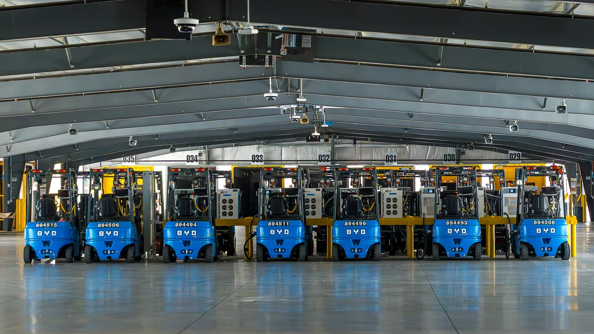 Electric forklifts are parked inside Estes' new LTL terminal in Banning, California.