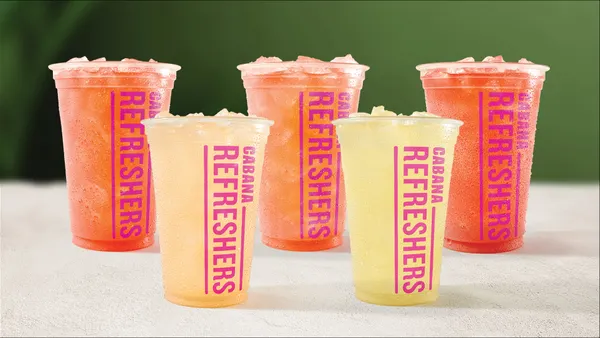 A photograph of five fruit drinks within plastic cups.