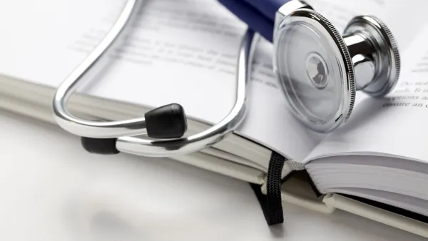 A stethoscope rests on a book.