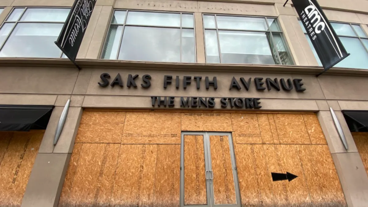 The boarded up entrance of a Saks Fifth Avenue Men's store.