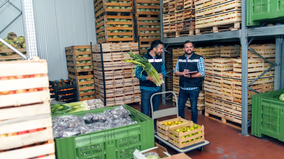 Staff with fresh vegetables in warehouse