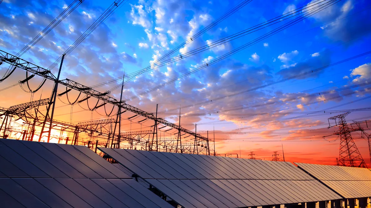 Solar photovoltaic panels and a substation in the evening.