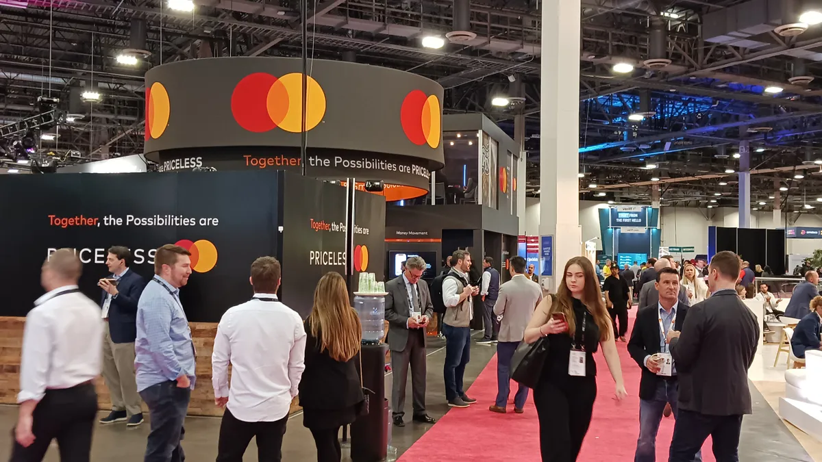 People walking the trade show floor at a conference.