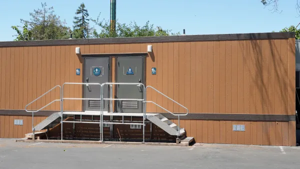 A bathroom trailer on a construction jobsite.