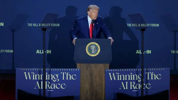 A man speaks at a podium.