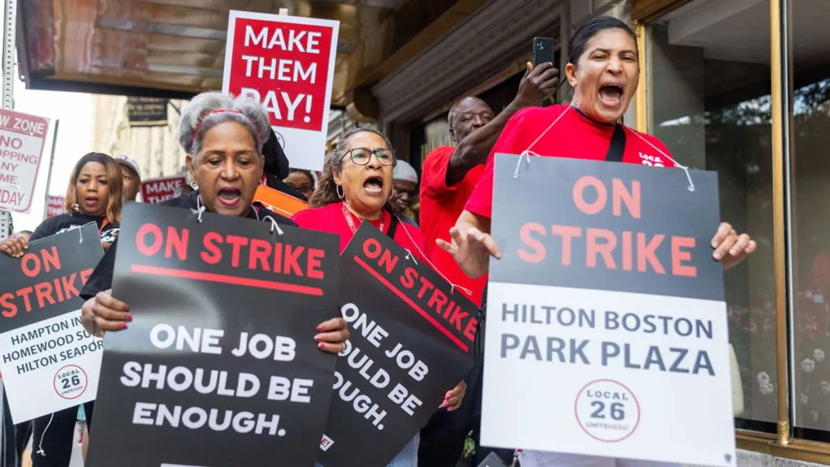 People hold signs reading "ON STRIKE."