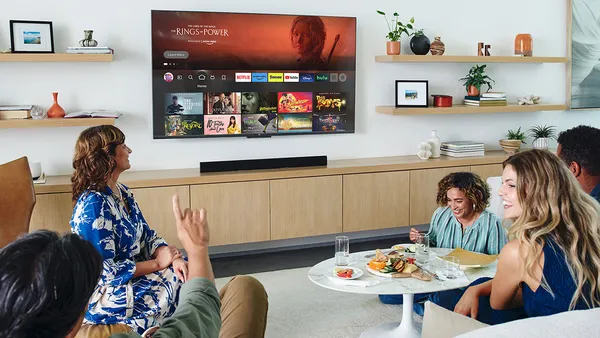 People in a living room watch an Amazon Fire TV