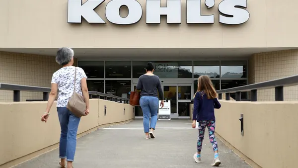 Customers enter a Kohl's store on an elevated walkway.