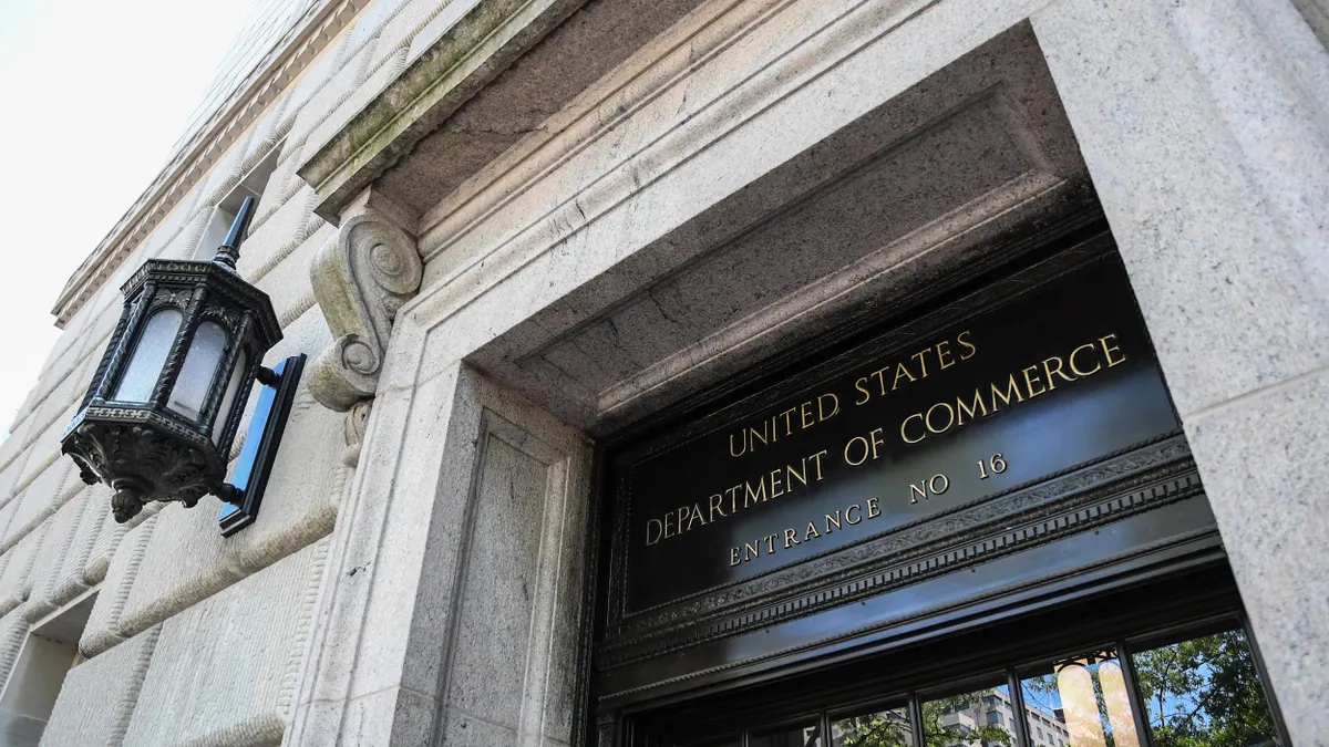 A Greek revival-style building facade with a sign that reads "United States Department of Commerce, Entrance NO 16." 