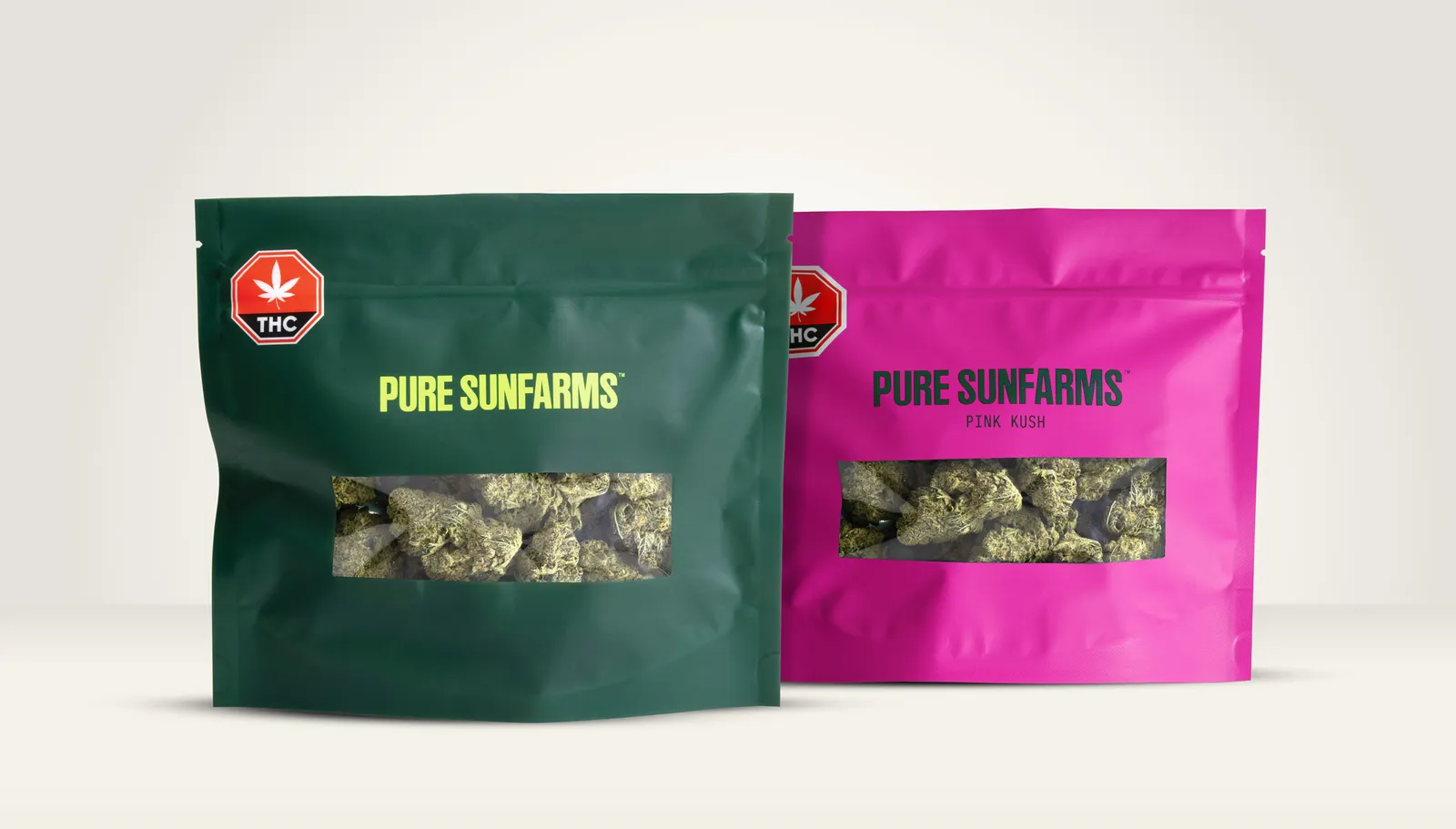 One green pouch and one fuschia pouch have clear windows that show a cannabis product inside, with branding on the exterior for Pure Sunfarms.