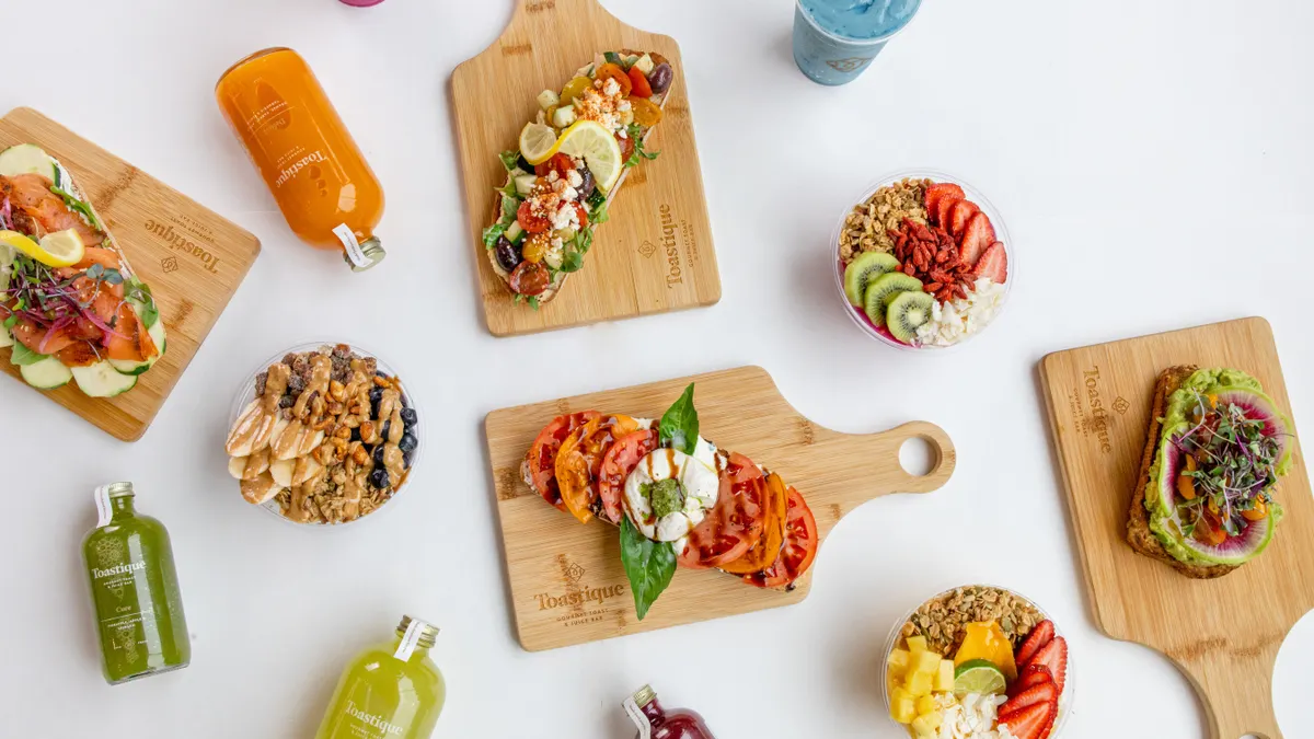 Toast, juice and bowls spread out against a white background.