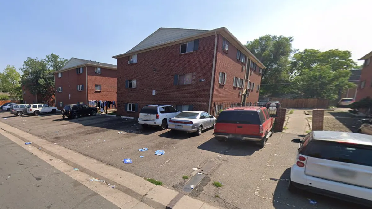 A low-rise brick apartment building.