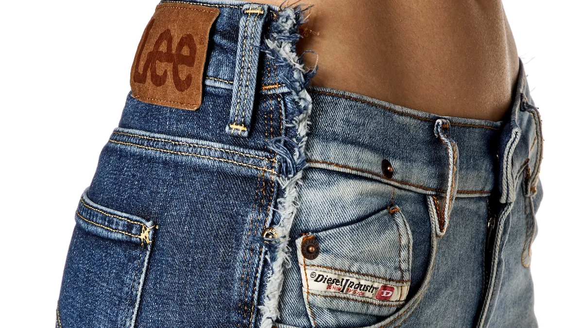 A pair of denim jeans that is half Diesel and half Lee.