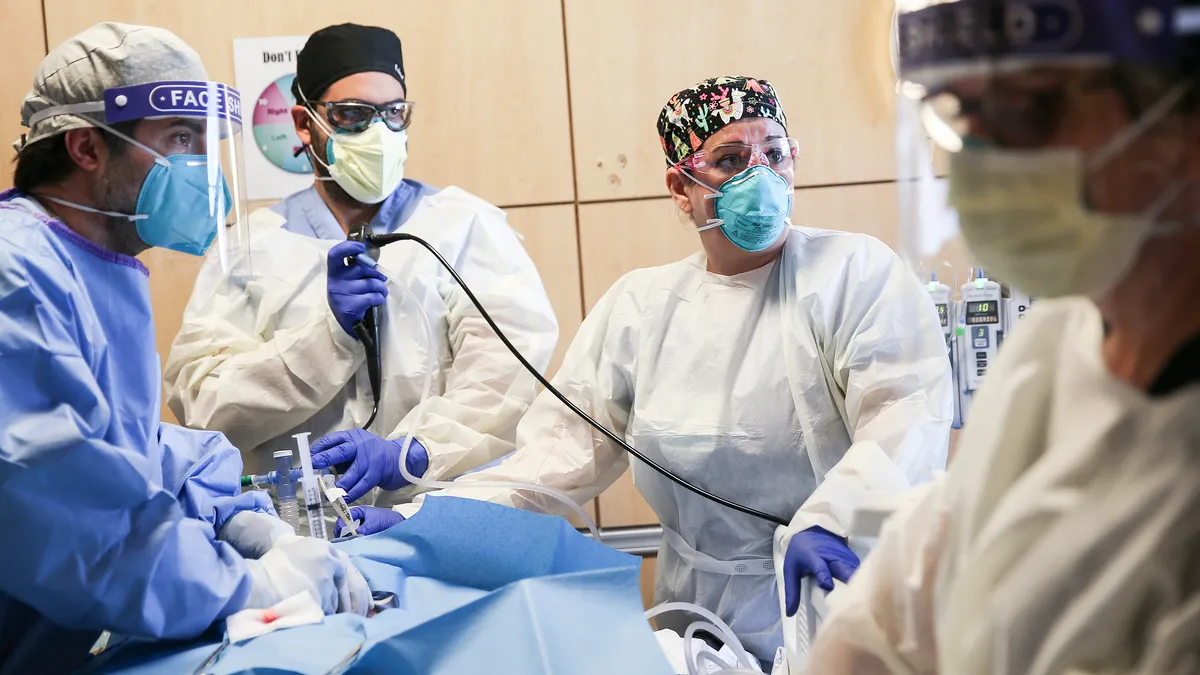 Surgeons treating a patient who is lying on a n operating table