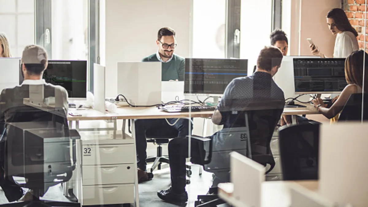 Large group of computer programmers working in the office.