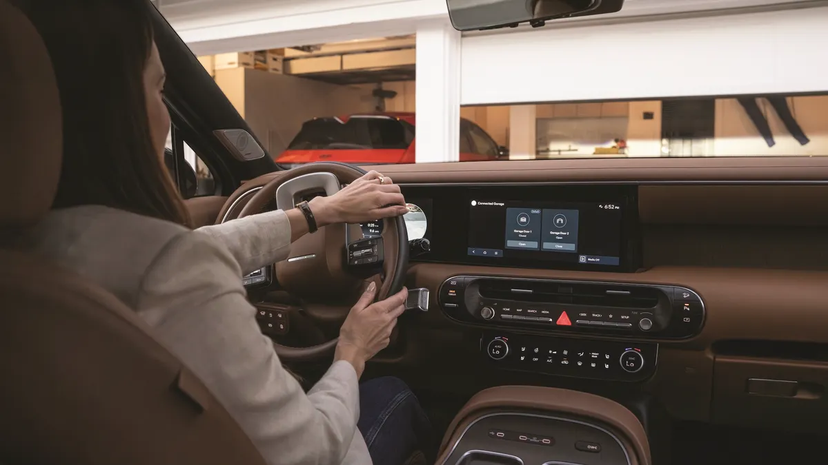 A driver uses the Hyundai myQ Connected Garage in a Hyundai Palisade SUV.