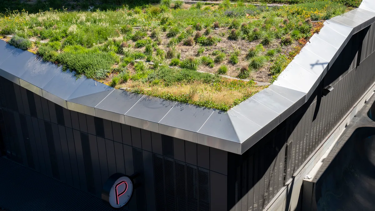 Aerial view of vegetation on the roof of a large building.