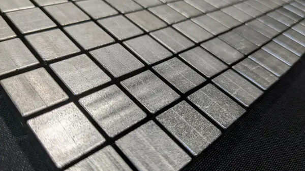 A group of square-shaped rare-earth-free permanent magnets produced by Niron Magnetics laid out in a grid.