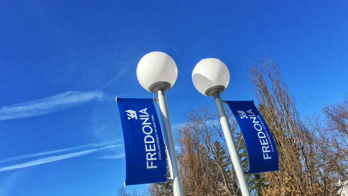 A SUNY Fredonia flag flies on a cold day.