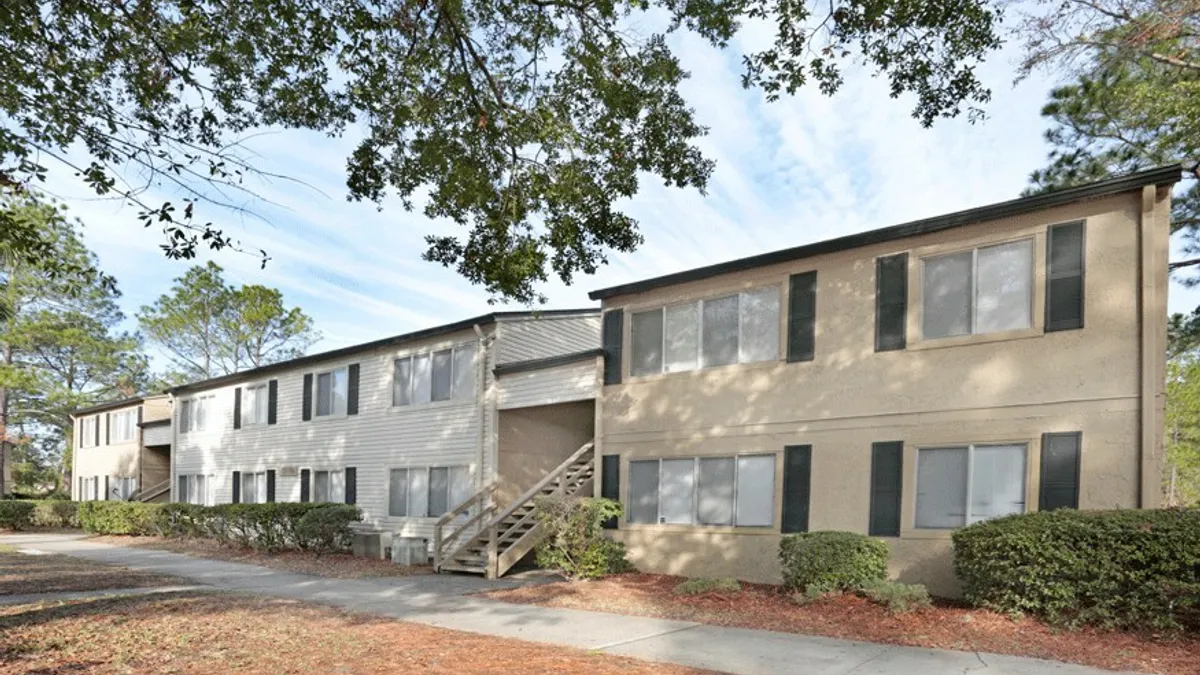 Older, brown, garden-style apartments