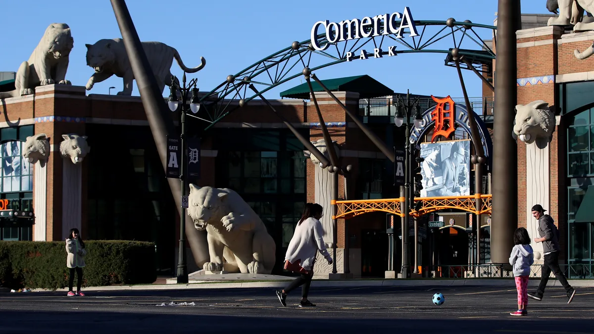 A family plays kick ball outside Comerica Park, home of the Detroit Tigers, in Detroit on April 2, 2020.