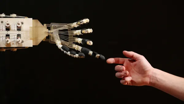 Robotic hand reaches out to touch human hand