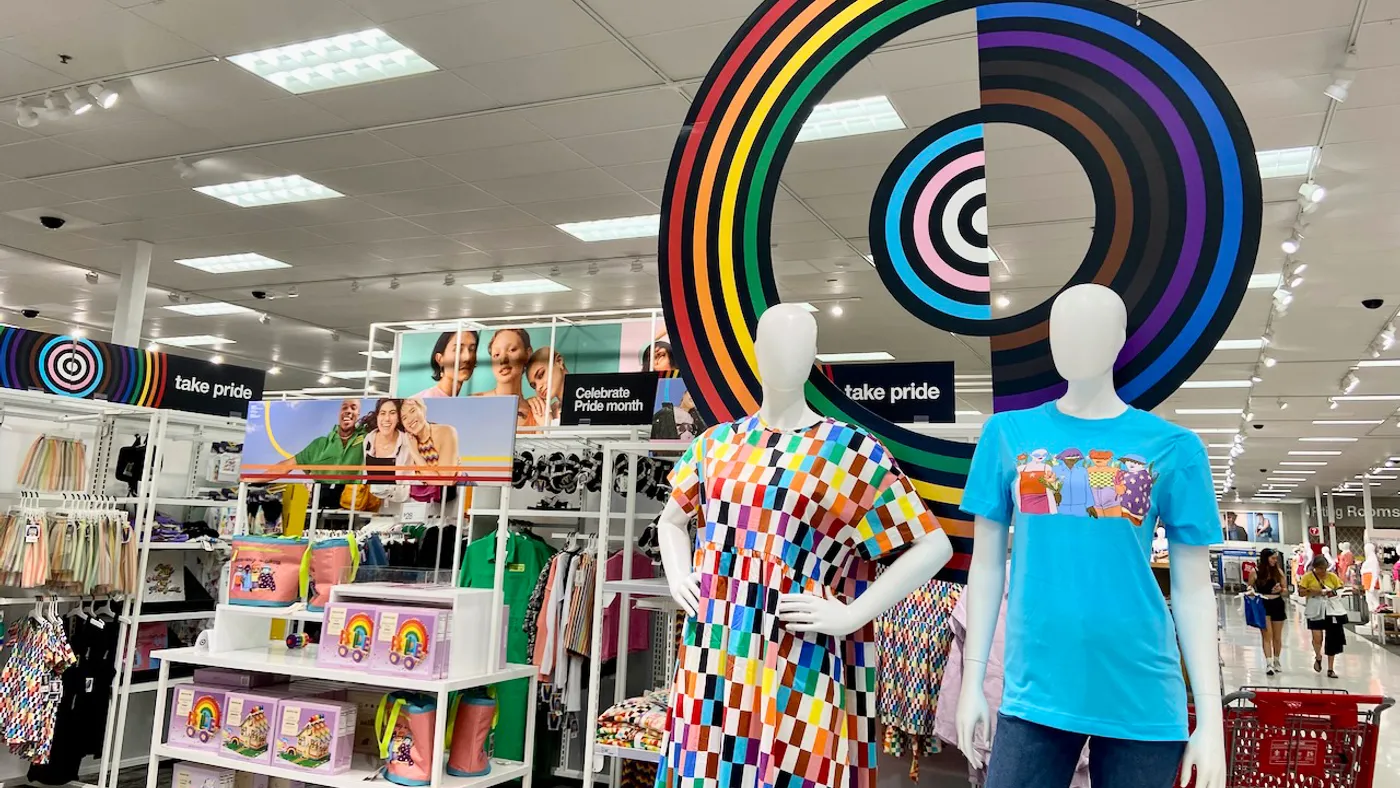 A display of apparel and other colorful items, including mannequins and bright signage.