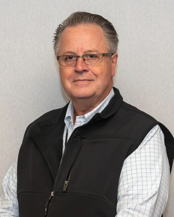 Chris Durley, AAA Cooper president of LTL services, smiles in glasses and a vest in a company photo