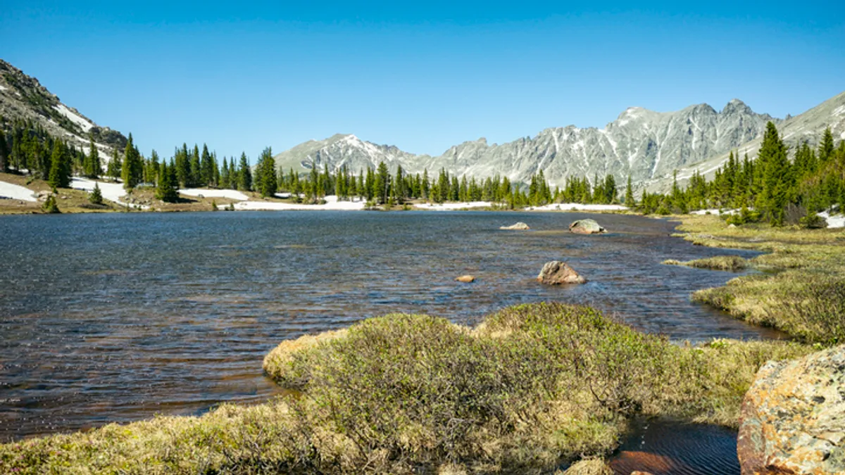 A small lake surrounded by mountains