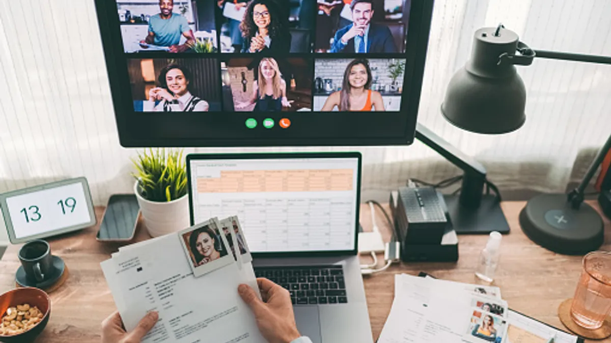 Person holds a resume while on a video call