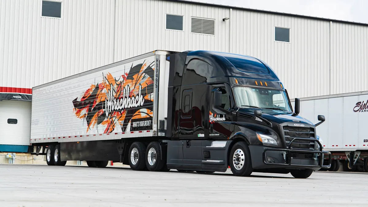 A Hirschbach Motor Lines tractor and trailer next to a facility.