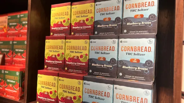 A shelf displays THC seltzer in a store front, featuring blueberry and rapsberry flavors.