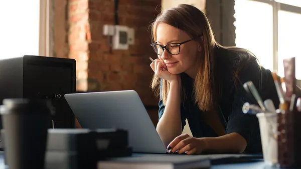 A girl works at a computer in a modern office