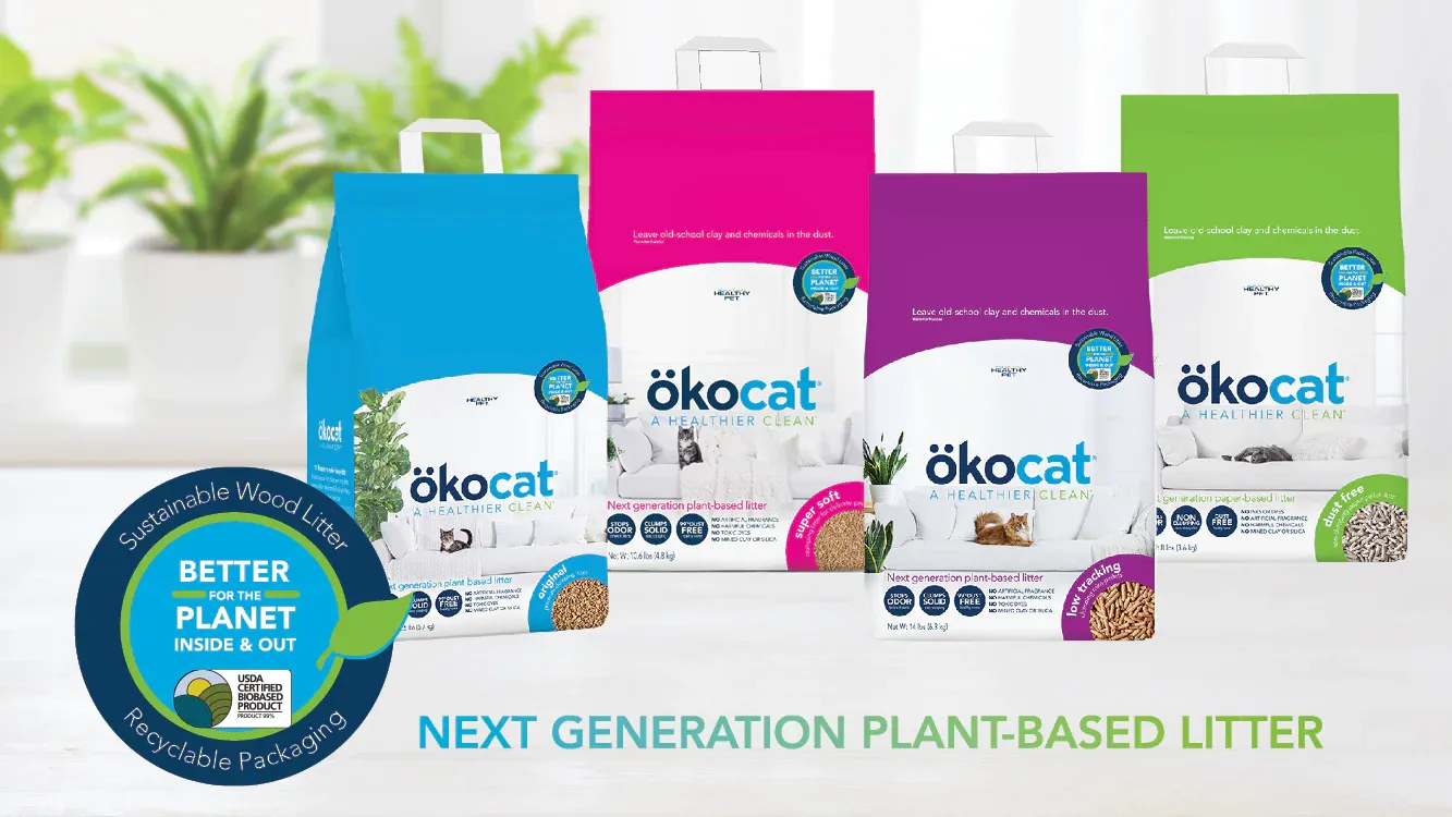 Four bags of ökocat cat litter printed with blue, green, pink and purple branding designs.