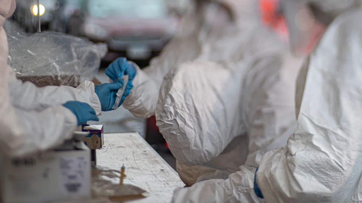 Medical technicians process specimens at a COVID-19 Community-Based Testing Site at the PNC Bank Arts Center in Holmdel, N.J., March 23, 2020. The testing site, established in partnership with the Fed