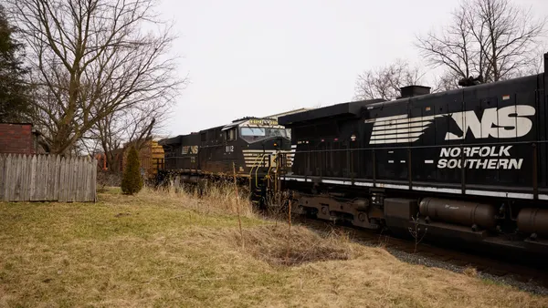 A Norfolk Southern train in Ohio passing through a neighborhood.