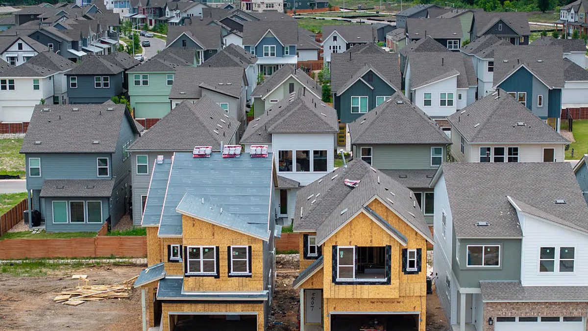 An aerial view of houses in various stages of construction.