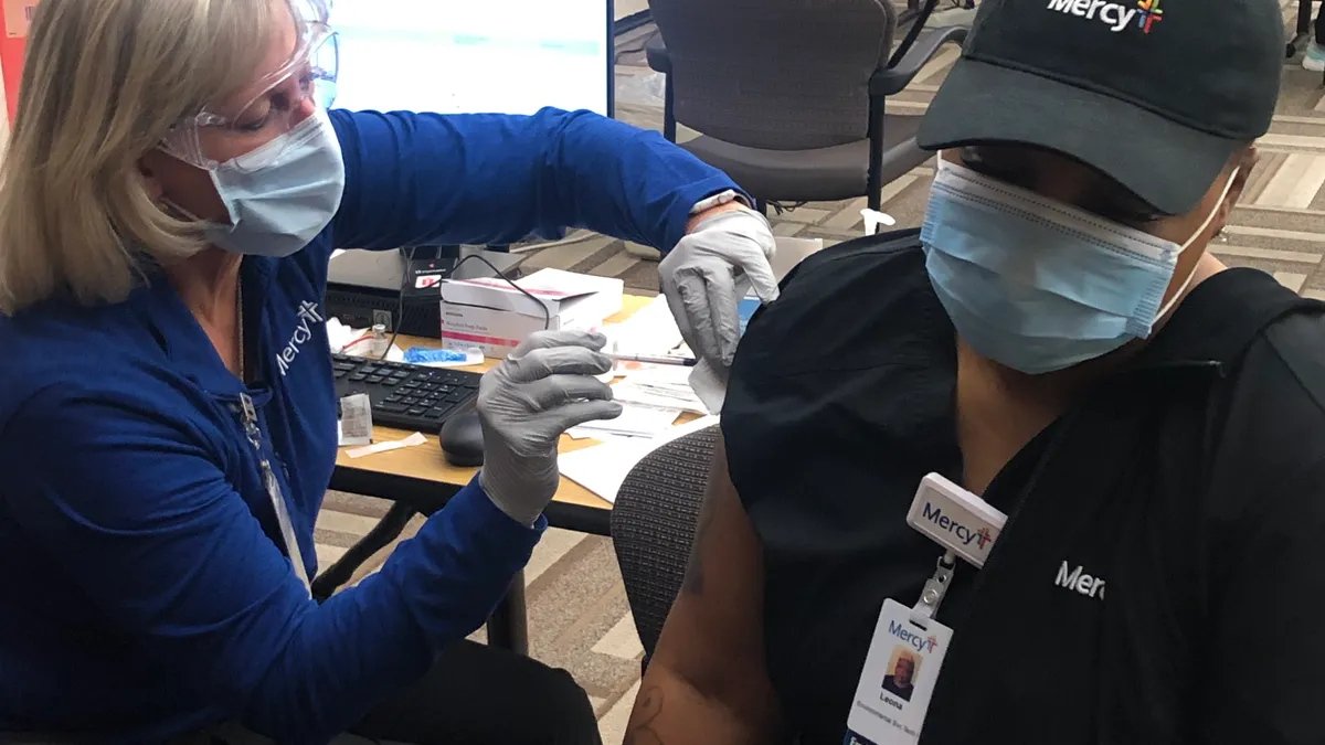 Leona Bell, a housekeeper for Mercy in St. Louis, was among the first to receive the COVID-19 vaccine in the area. Hospitals across the country received the first doses on Monday, Dec. 14 2020.