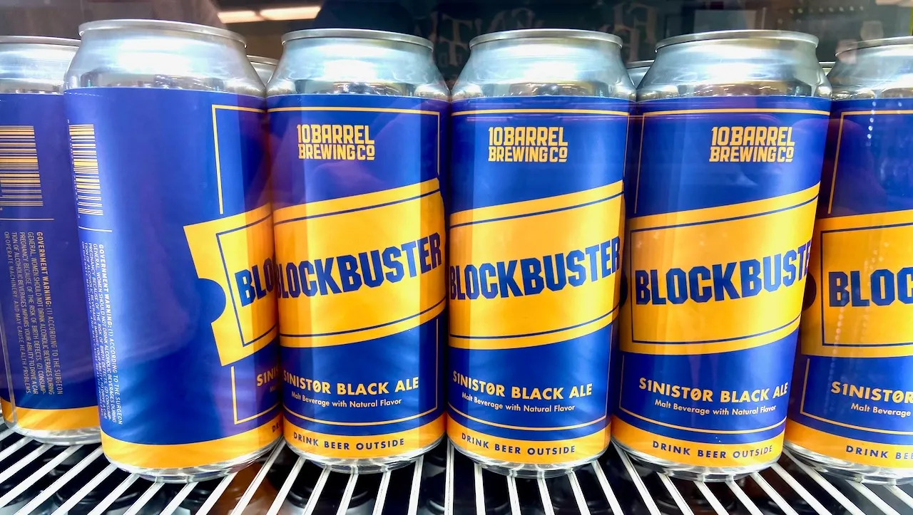 A row of blue and yellow beer cans.