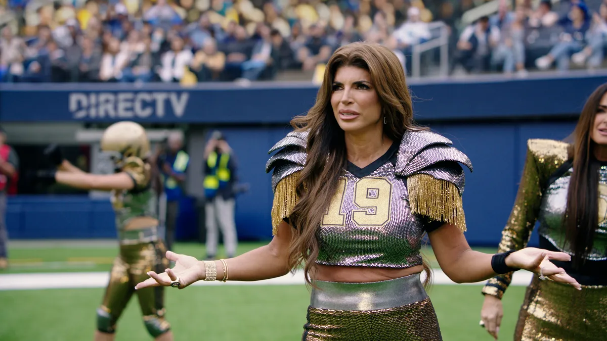 Reality TV star Teresa Giudice wears football gear in a DirecTV commercial