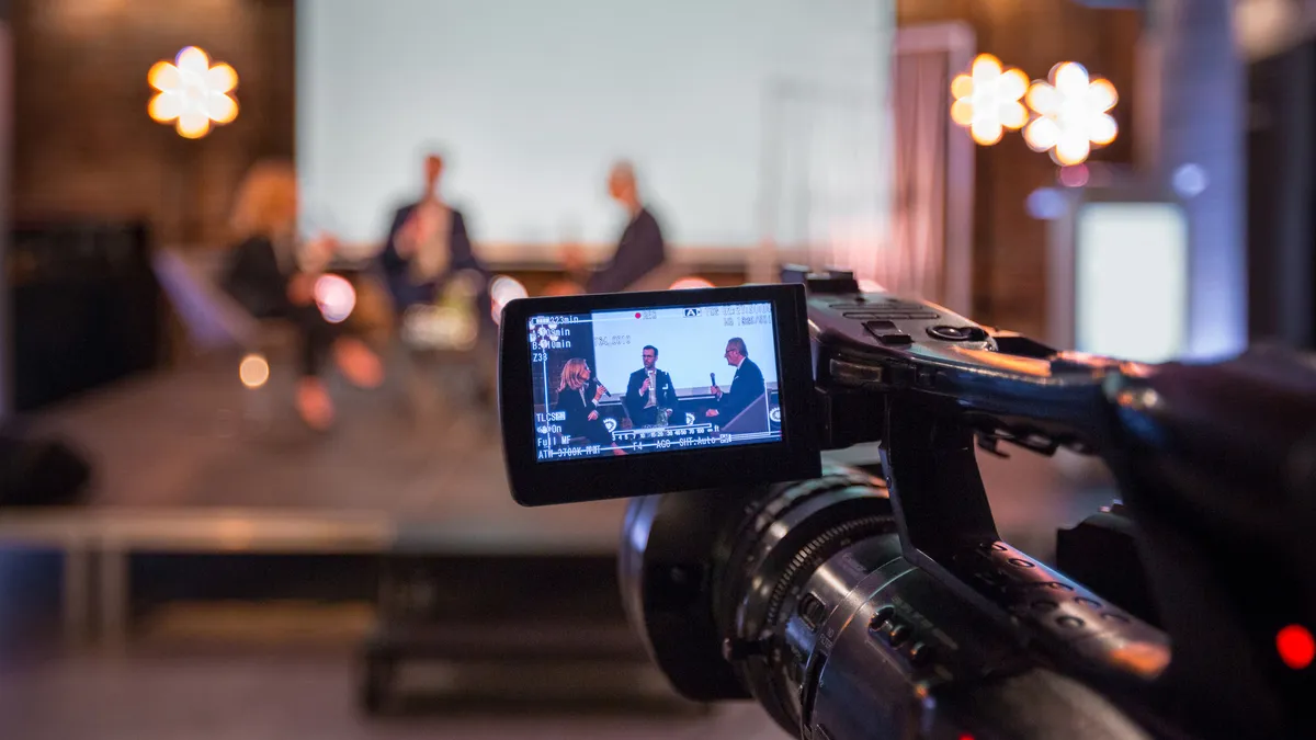 man and women in front of camera at an online webinar