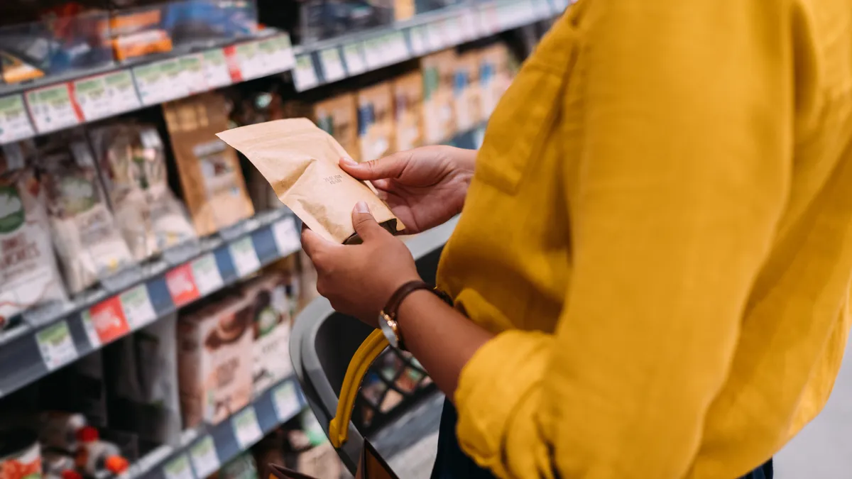 Customer holding and looking at pouch packaging