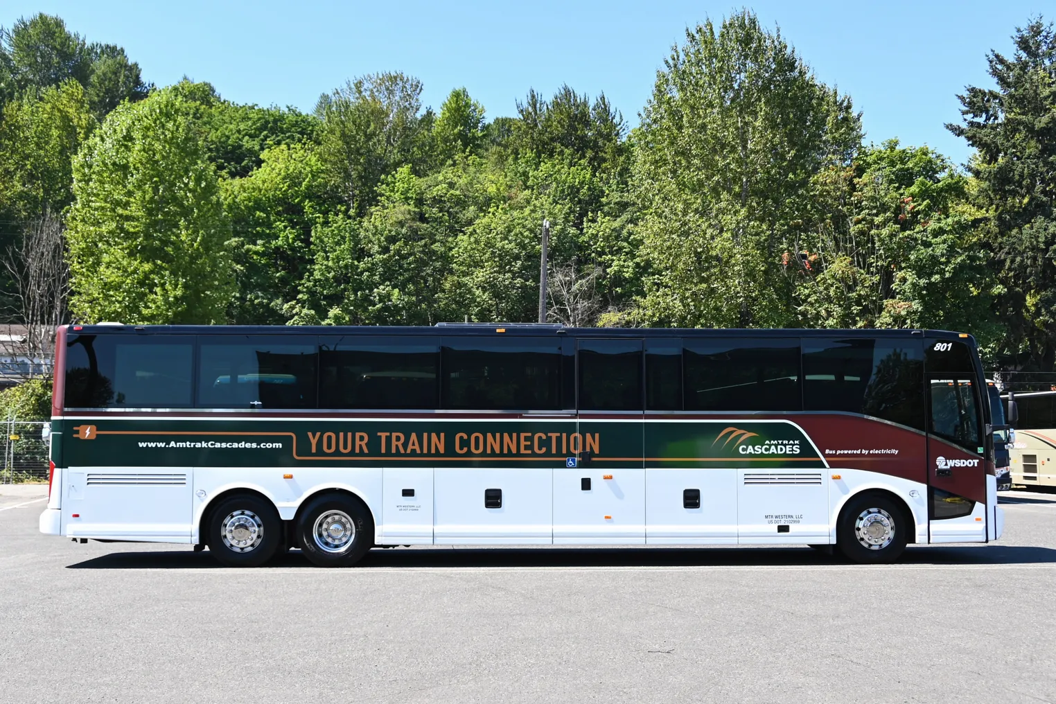 Side view of electric motor coach with Amtrak livery.