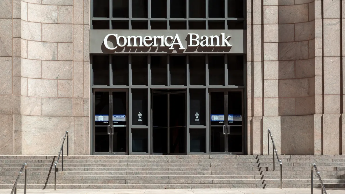The entrance to a stone Comerica Bank building entrance is shown, with stone stairs in the foreground.