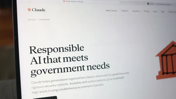 A laptop screen shows the website for Anthropic's Claude AI tool displaying the words, "Responsible AI that meets government needs."