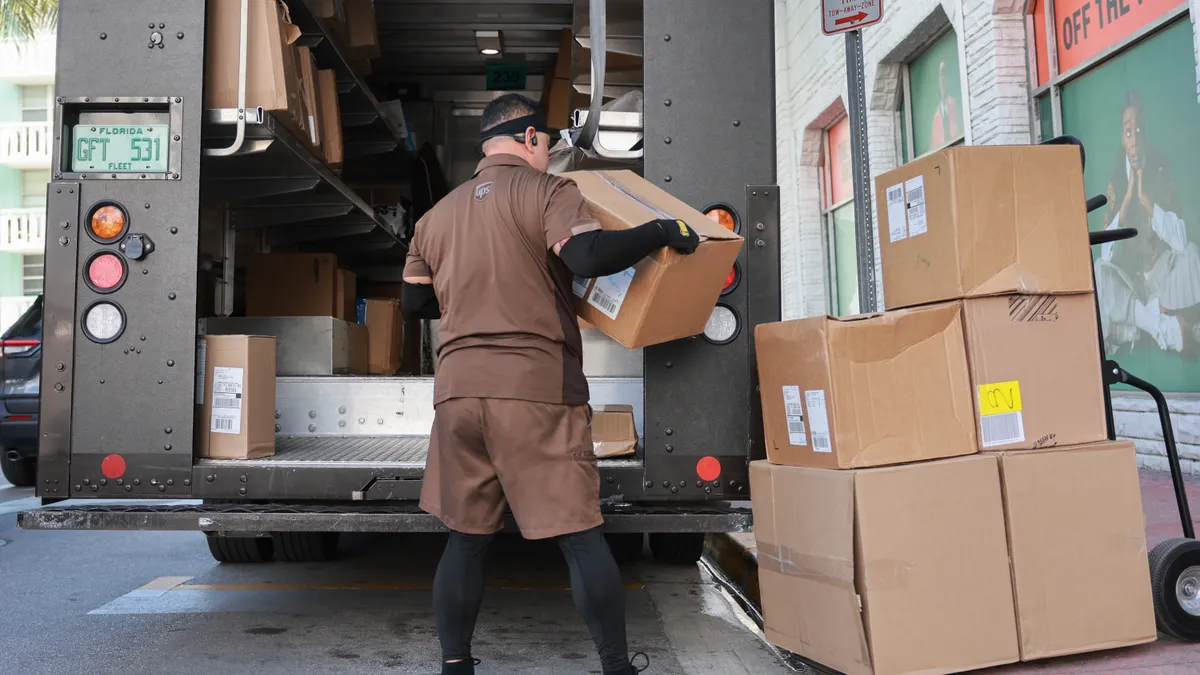 A UPS driver makes a delivery on January 30, 2024 in Miami Beach, Florida.