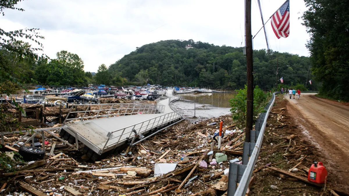 Debris from Hurricane Helene cover the ground.