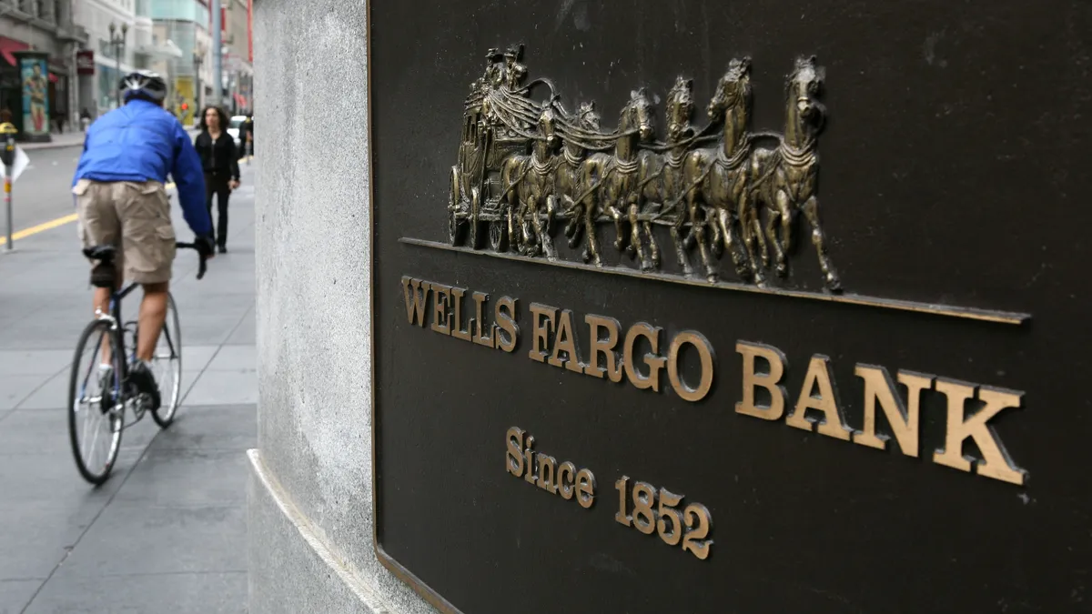 A bicyclist rides by a Wells Fargo bank branch in San Francisco, California