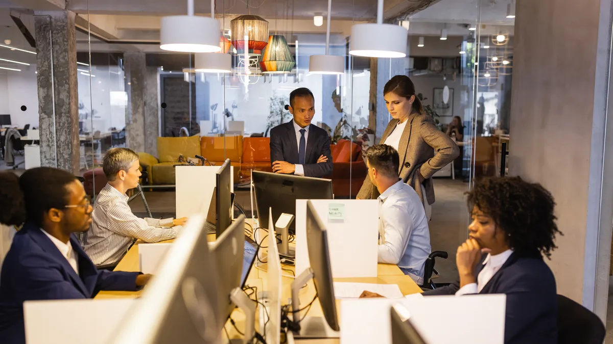 A group of employees work together seriously in an office