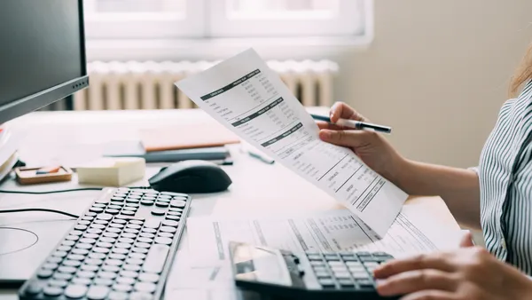Female Accountant Analyzing the Company's Financial Records